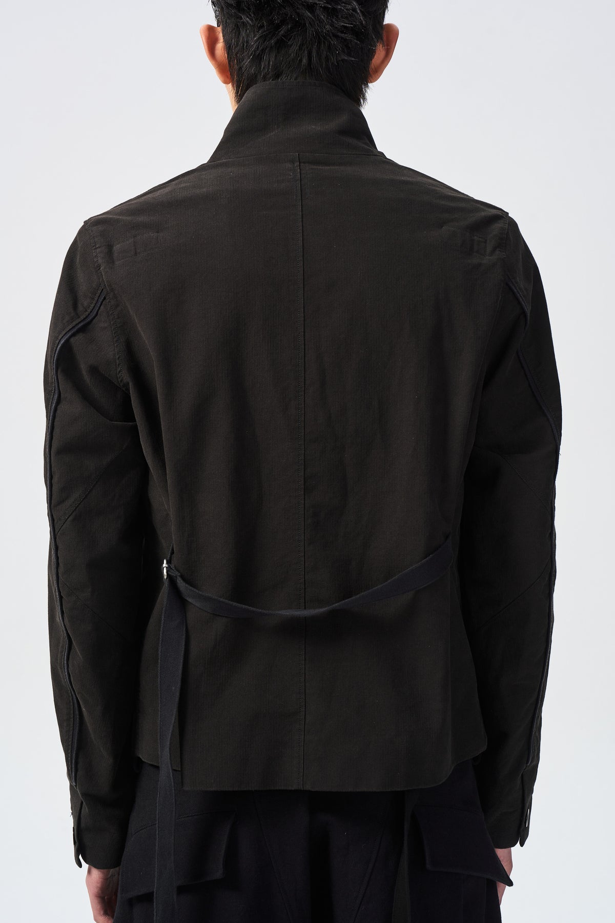 ARNO OFFSET JACKET — back webbing and hem detail — ATTEMPT AW26