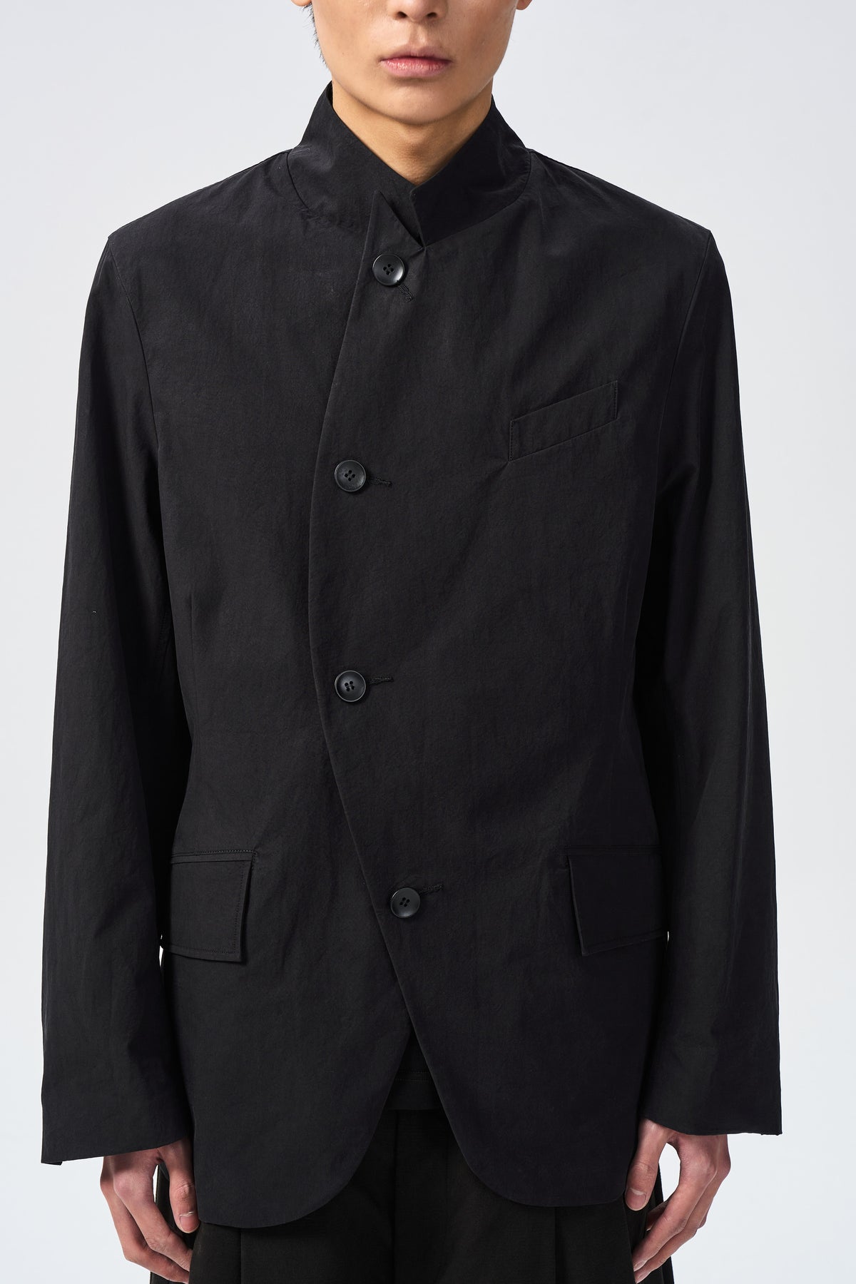 ARC BLAZER — curved front closure and pocket detail — ATTEMPT AW26